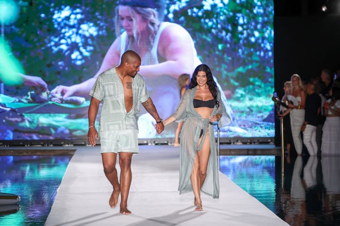 Larry English and Nicole Williams English walks the runway for Sports Illustrated Swimsuit Runway Show During Paraiso Miami Beach on July 16, 2022 in Miami Beach, Florida.